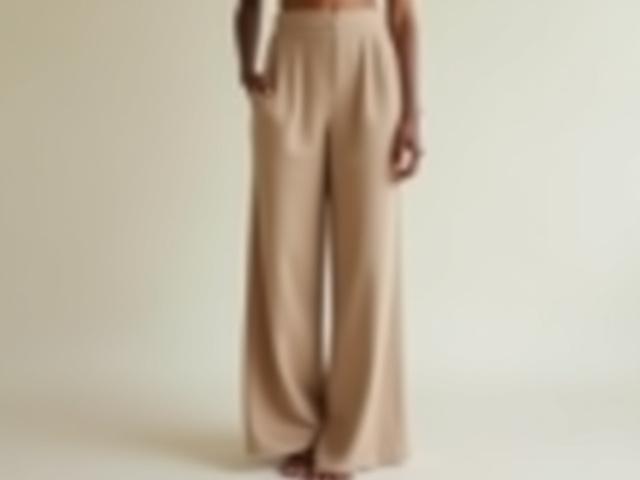 Model wearing elegant wide-leg natural fabric trousers, paired with a simple top